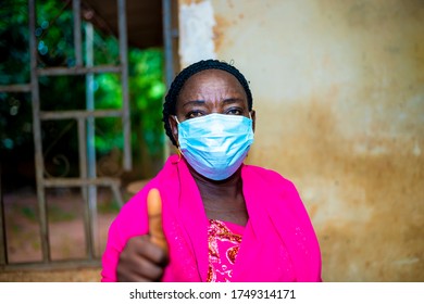 Elderly Black African Woman Wearing Face Mask  Influencing Others People To Use Face Mask When Going Out . Black Senior Woman Wearing Face Doing A Thumps Up Sign