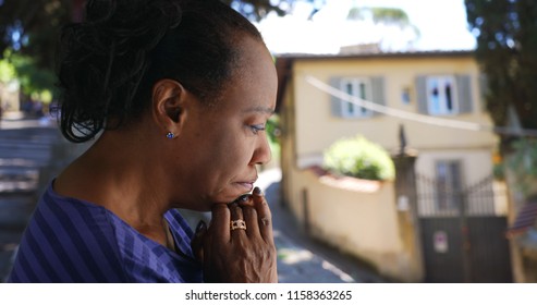 Elderly Black Woman Standing Outside Praying