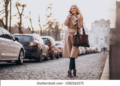 Elderly Business Woman With Phone Walking Down The Street