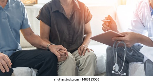 Elderly Couple, Ageing Senior Patients Having Exam And Family Consultation In Clinic With Doctor, Physician Or Therapist On Menopause Illness, Mental Health Care, And Geriatric Syndrome Screening