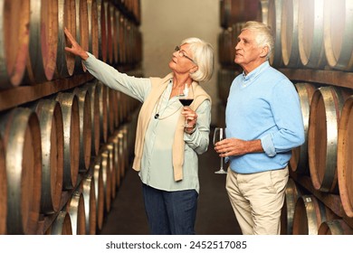 Elderly couple, cellar and glass for wine tasting, retirement and france holiday together. Mature man, woman and romance with winery date, vacation and alcohol drink for anniversary and happiness - Powered by Shutterstock