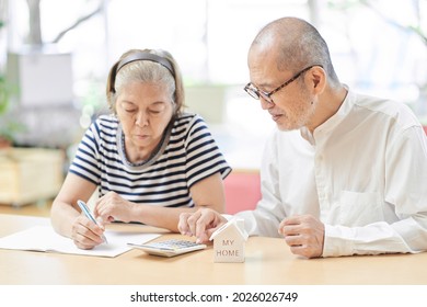 Elderly couple consulting real estate - Shutterstock ID 2026026749