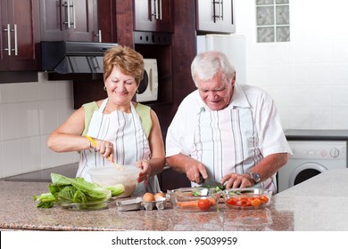 Elderly Couple Cooking In Home Kitchen