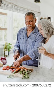 Elderly couple cooking in a kitchen - Shutterstock ID 2007633272