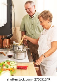 Elderly Couple Cooking Together In Kitchen