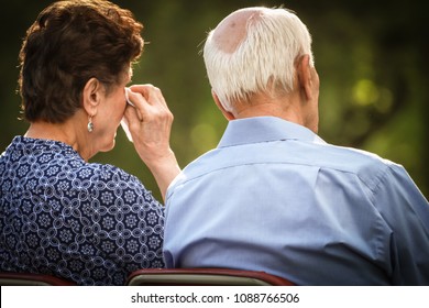 Elderly Couple Crying And Watching Sad Or Happy Situation Together.