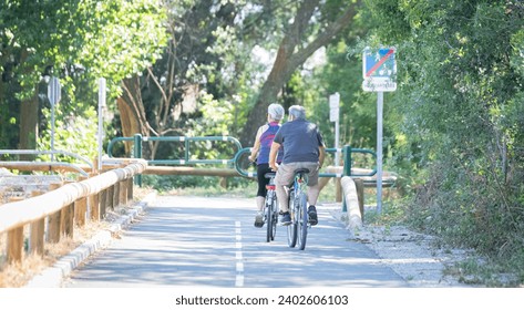 Elderly couple cycling on a cycle path.  - Powered by Shutterstock