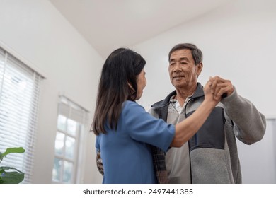 Elderly Couple Dancing Together at Home, Sharing a Joyful Moment in a Bright and Cozy Living Room - Powered by Shutterstock