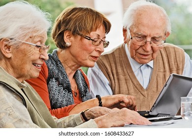 Elderly Couple And Daughter Making Plans