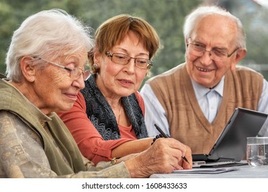 Elderly Couple And Daughter Making Plans