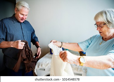 Elderly Couple Doing Laundry