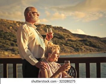 Elderly Couple Drinking A Glass Of Wine