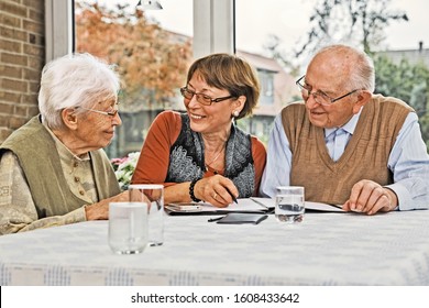 Elderly Couple And Dughter Making Plans