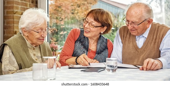 Elderly Couple And Dughter Making Plans