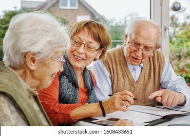 Elderly Couple And Dughter Making Plans