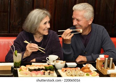 Elderly Couple Eating Sushi In A Cafe