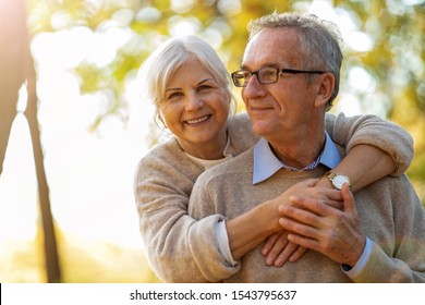 Elderly couple embracing in autumn park 
 - Powered by Shutterstock