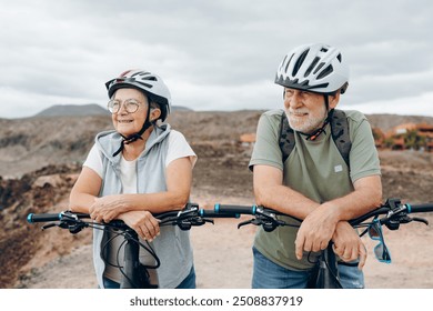 Elderly couple embracing in rocky beach outdoors having fun and enjoying together looking at the sea. Two old and mature people in love caring each other. - Powered by Shutterstock