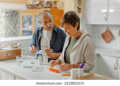 An elderly couple engages in a thoughtful discussion about medication management within a cozy kitchen setting, standing in casual clothing. Organizing pill box, daily routine at home. Horizontal - Powered by Shutterstock