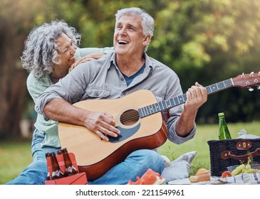 Elderly, couple and guitar at happy picnic in garden, park or nature together. Man, woman and music for happiness on travel to countryside for lunch, food or relax with love by trees in sunshine - Powered by Shutterstock