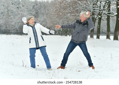 Elderly Couple Having Fun Outdoors In Winter Forest