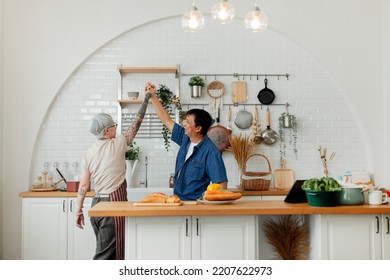 An Elderly Couple Having A Meal Together. Senior Couple Having Fun Cooking Together In The Kitchen. Healthy Lifestyle Concept Happy Family Happy Time, Holiday, Cooking