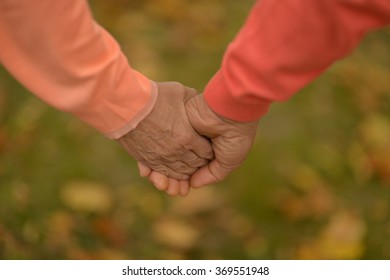 Elderly Couple Holding Hands