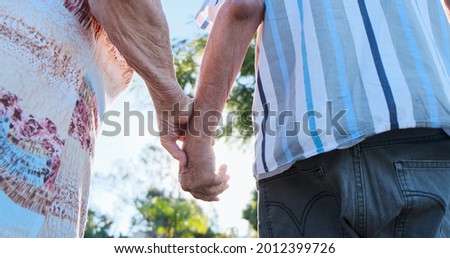 elderly couple holding hands and close up