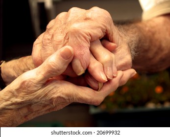 Elderly couple holding hands with love - Powered by Shutterstock