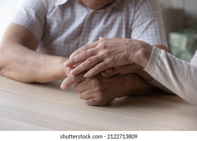 Elderly Couple Holding Hands With Love And Support Close Up. Mature Wife Giving Comfort, Empathy To Old Husband At Moment Of Stress, Grief, Despair, Disease. Family, Marriage Concept. Cropped Shot