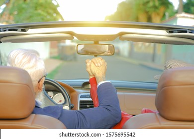 Elderly Couple Holding Hands While Sitting Together At Car. Loving Couple Holding Hands In Car. Close Up Shot Of Loving Couple's Hands, Man And Woman On Travel Road. Traveler And Lovely Concept.