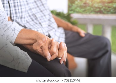 Elderly couple holding hands, Wife and husband sitting together, aged middle,   Concept of take care together.
