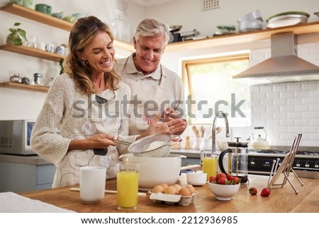 Elderly, couple and in kitchen while cooking, baking and happy together in funny moment. Senior man, woman and retirement smile in home, bonding and smile with love to make cookies, cake and bake