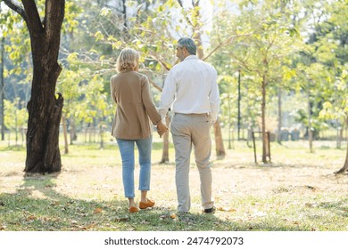 Elderly couple lifestyle concept. Husband and wife and sit walking in the park. - Powered by Shutterstock