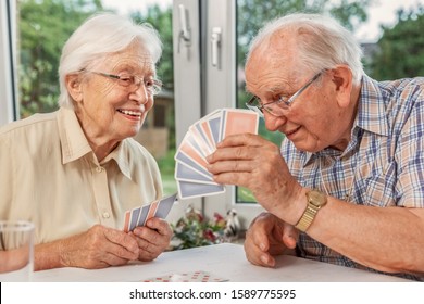 Elderly Couple In The Living Room, Playing Cards