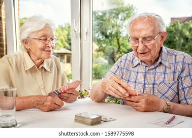 Elderly Couple In The Living Room, Playing Cards