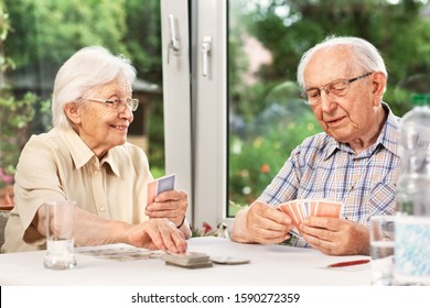 Elderly Couple In The Living Room, Playing Cards