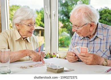 Elderly Couple In The Living Room, Playing Cards