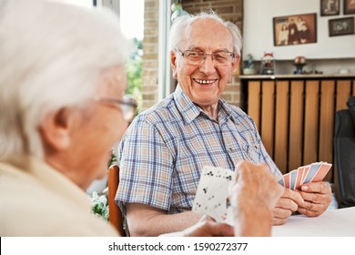 Elderly Couple In The Living Room, Playing Cards