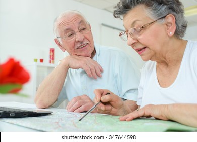 Elderly Couple Looking At Map