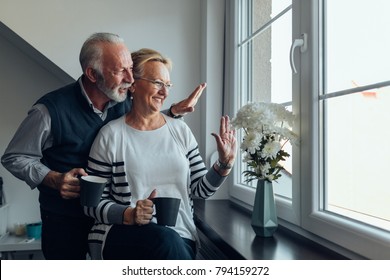 Elderly couple looking out the window - Powered by Shutterstock