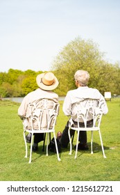 An Elderly Couple Of Men Sitting On Chairs Sun Bathing In Walton On The Naze, Essex