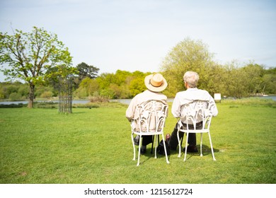 An Elderly Couple Of Men Sitting On Chairs Sun Bathing In Walton On The Naze, Essex