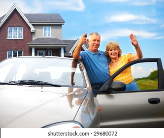 Elderly Couple Near Their Home.  Real Estate And Insurance Concept