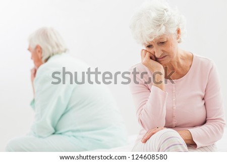 Elderly couple not talking to each other in bedroom
