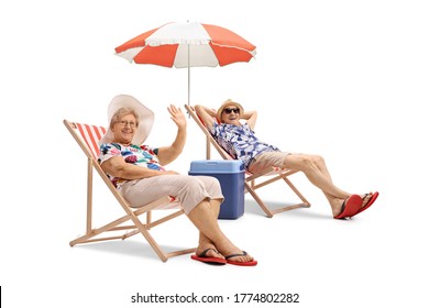 Elderly couple on a holiday sitting on deckchairs under umbrella and waving isolated on white background - Powered by Shutterstock