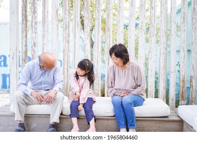 An Elderly Couple On A Leisure Trip With Their Grandchildren