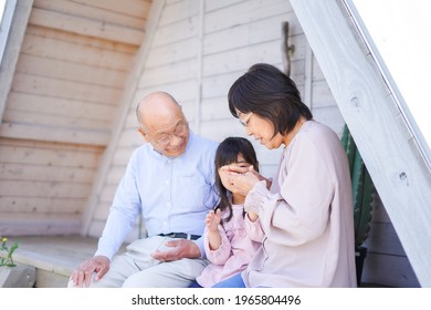 An Elderly Couple On A Leisure Trip With Their Grandchildren