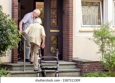 Elderly Couple on Stairs at the Font Door