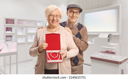 Elderly Couple With A Pearl Necklace And Bracelet In A Box Standing Inside A Jewlery Store